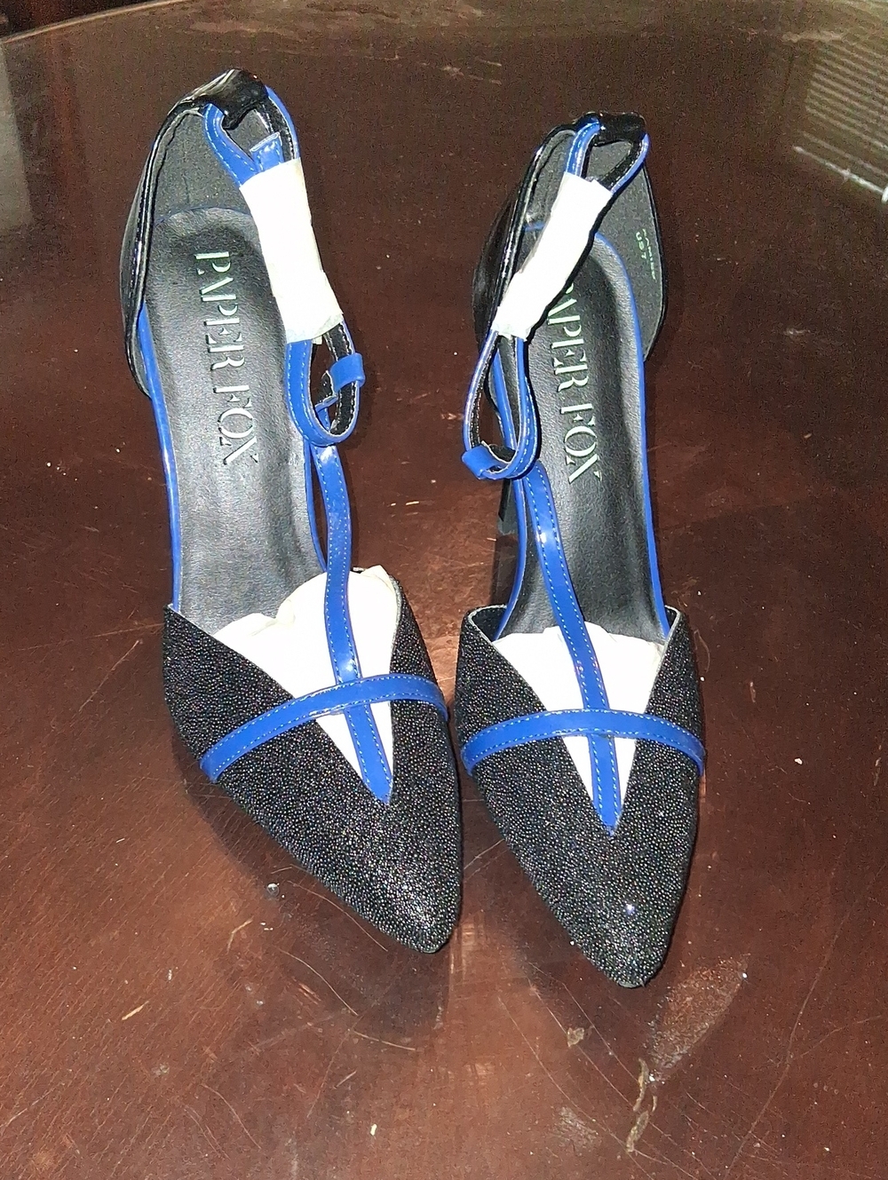 Paper Fox Black Sparkle Pointed-Toe T-Strap Heels with Blue Trim